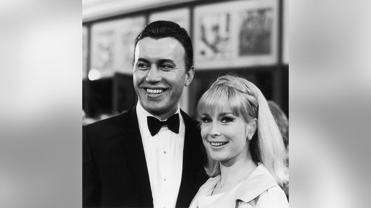 Michael Ansara in a tux and Barbara Eden wearing 1960s fashion