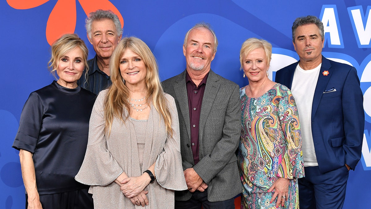 The cast of the Brady kids today smiling together on the red carpet