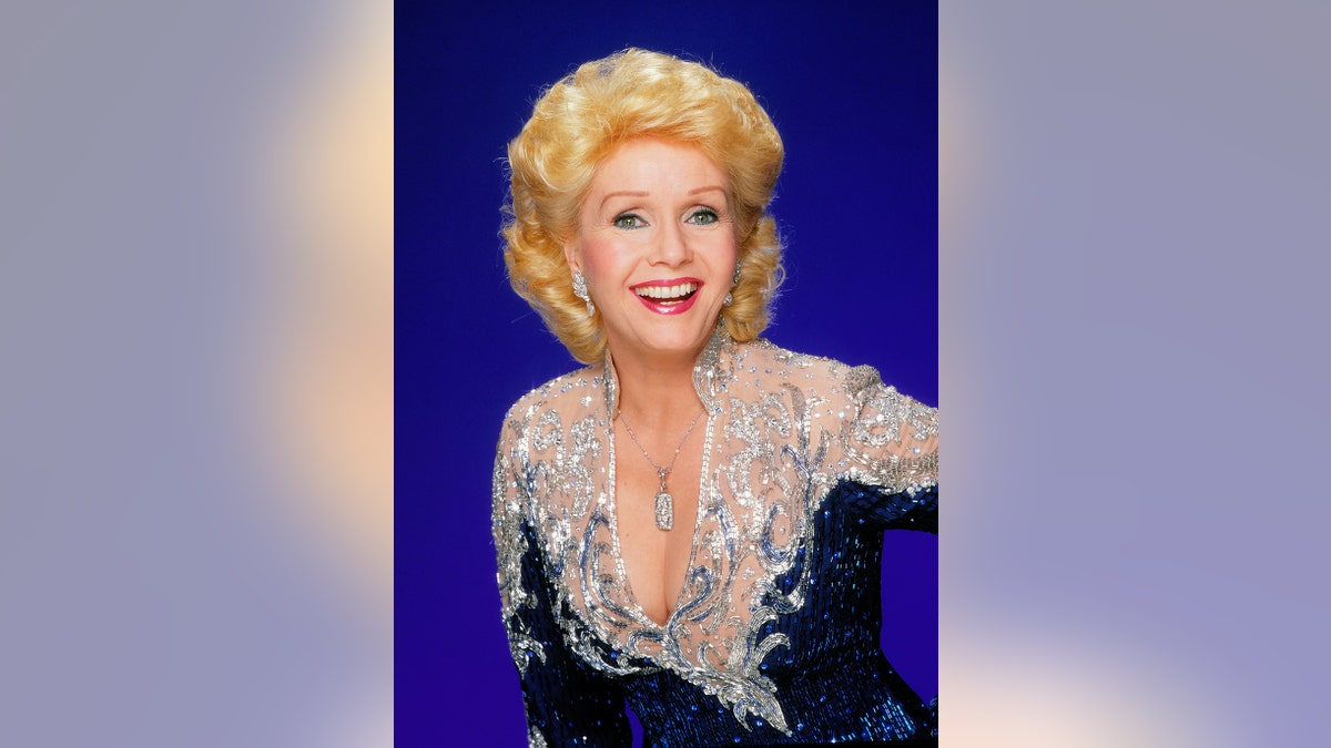 A close-up of Debbie Reynolds smiling with a sparkling gown