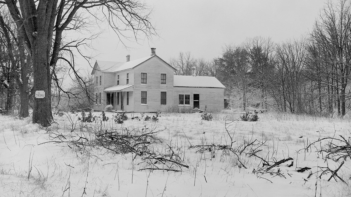 Ed Geins home surrounded by snow