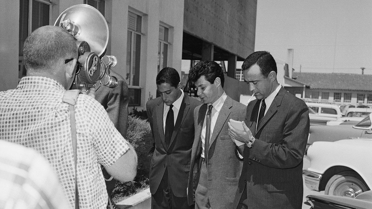 Eddie Fisher looking sad while walking to a court house