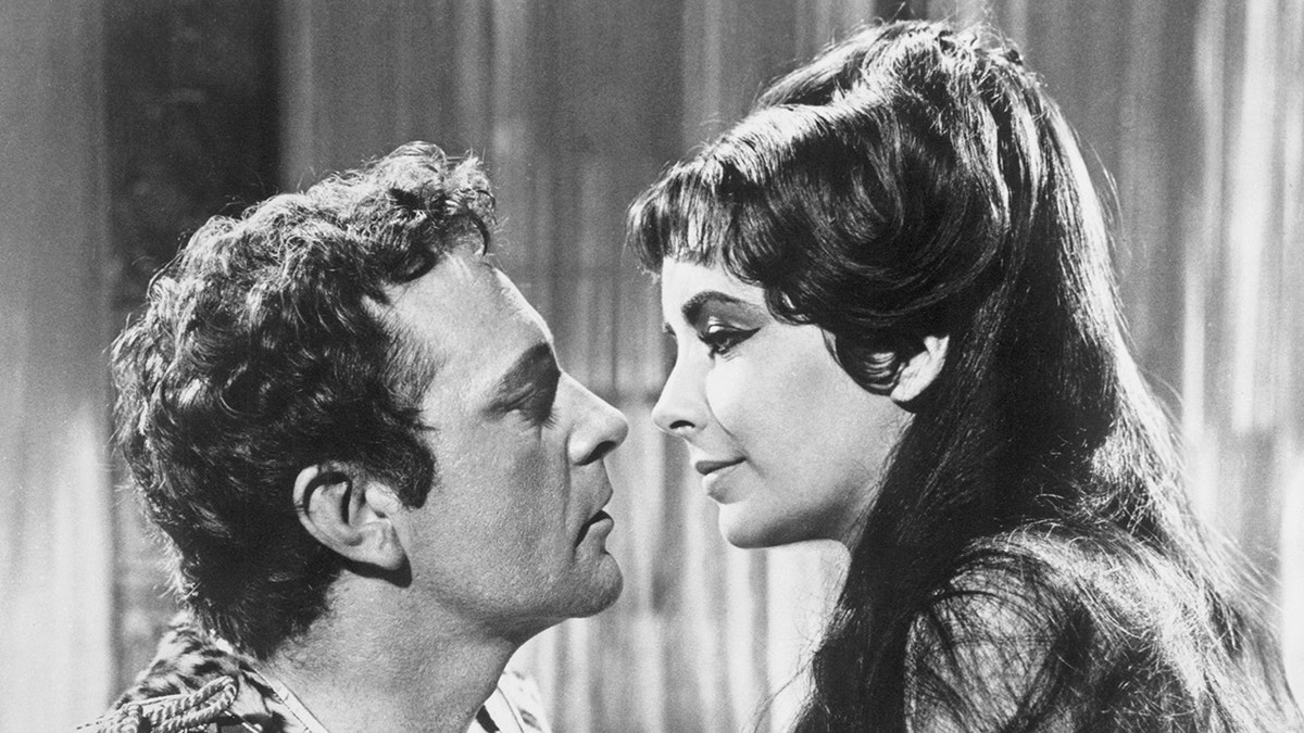 Richard Burton and Elizabeth Taylor going in for a kiss on the set of Cleopatra