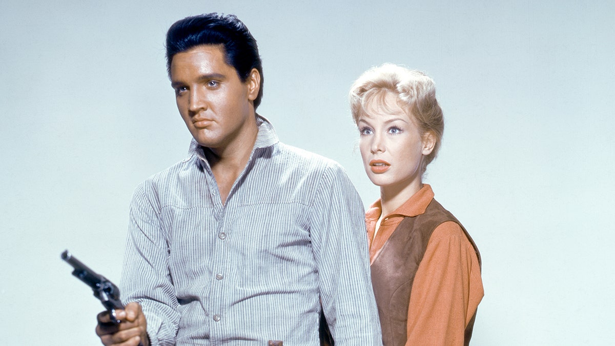 A close-up of Elvis Presley and Barbara Eden filming their Western movie