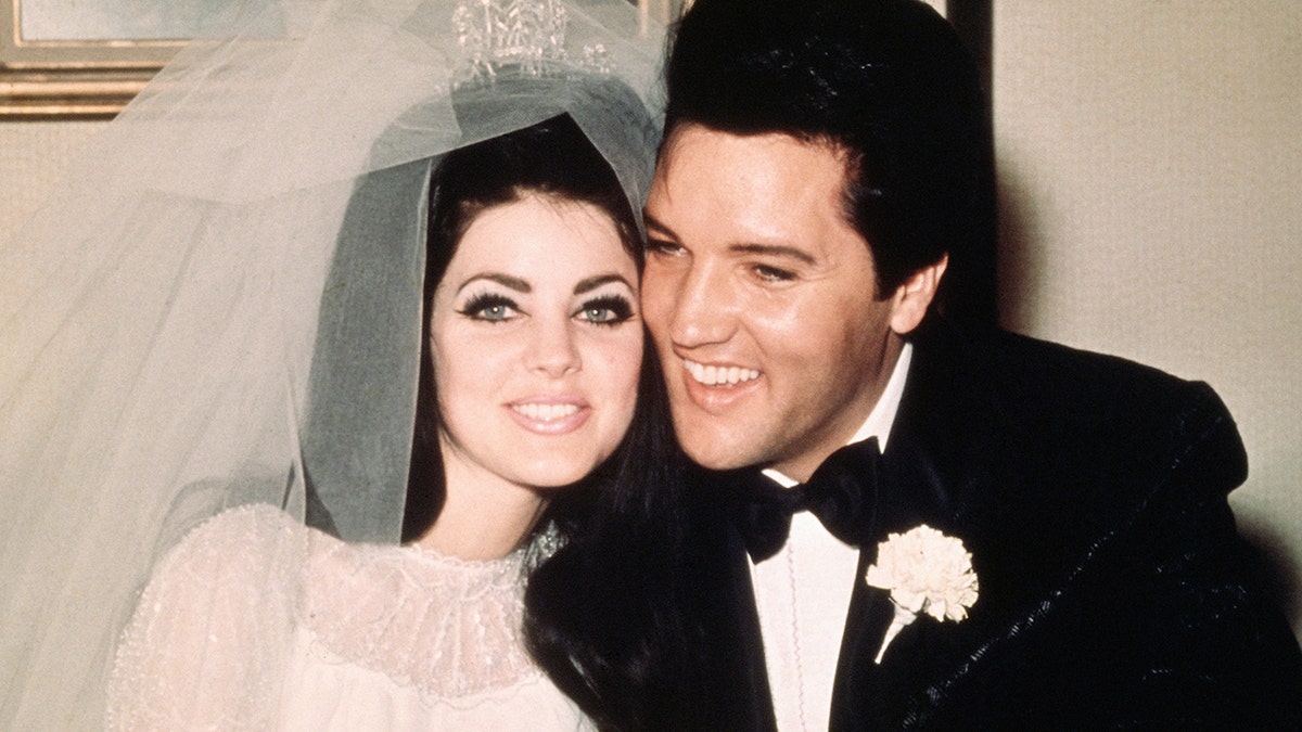 Elvis Presley and Priscilla Presley on their wedding day smiling