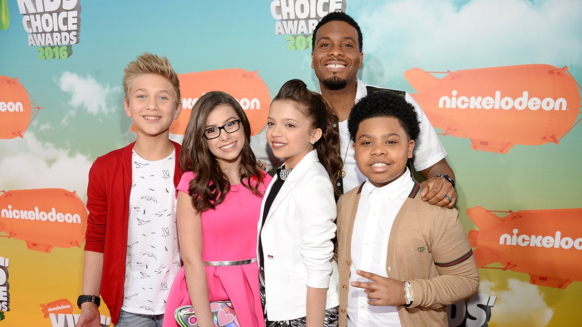 Cast of Game Shakers posing on the red carpet