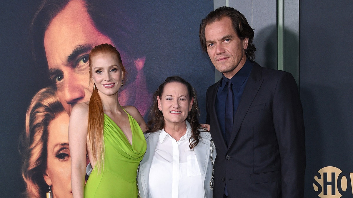 Jessica Chastain wearing a lime green halter dress, Georgette Jones wearing a white blouse and a grey blazer, and Michael Shannon in a black suit