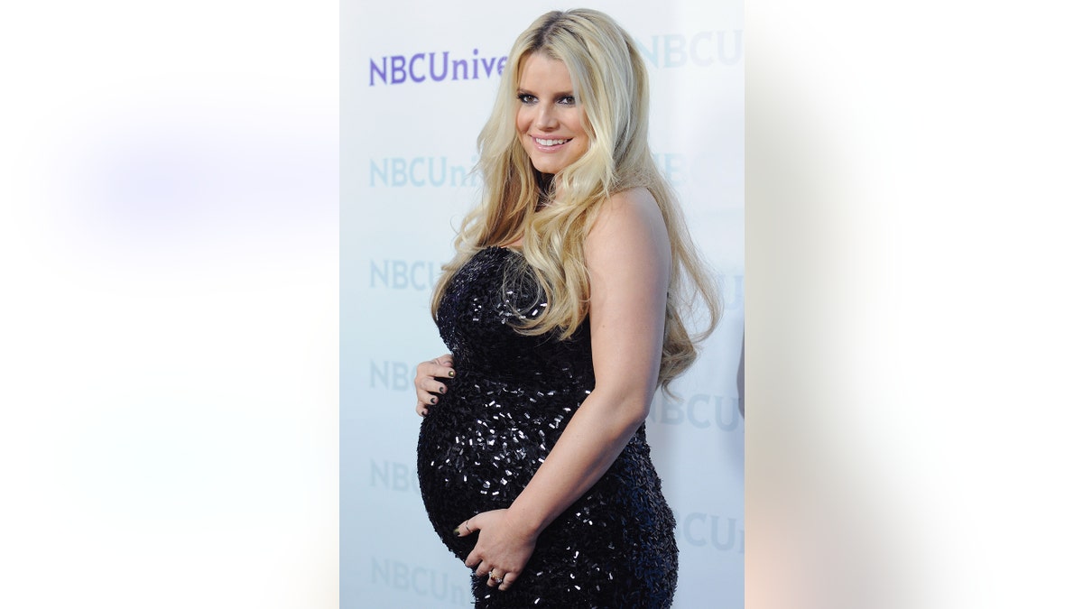 Jessica Simpson wearing a sparkling black dress while pregnant