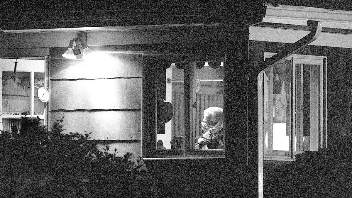 Joel Rifkins mother inside inside her home from the distance