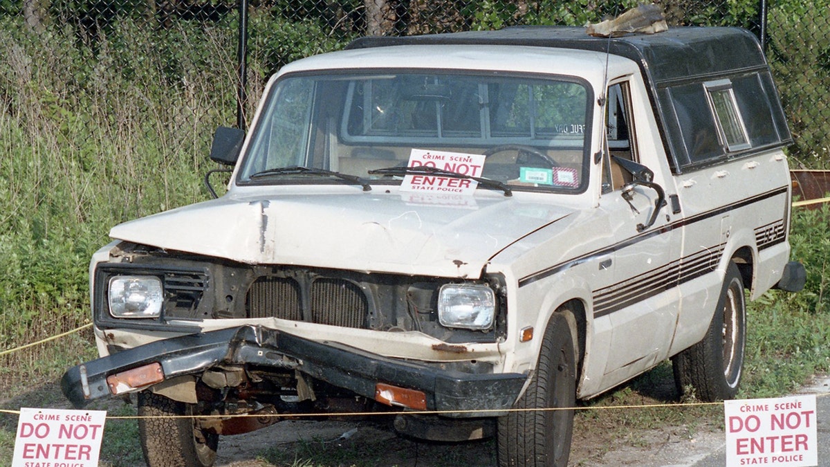 A white beat-up pickup truck