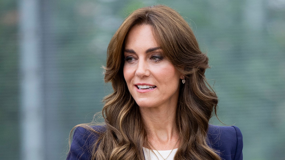 A close-up of Kate Middleton in a blue blazer and white shirt