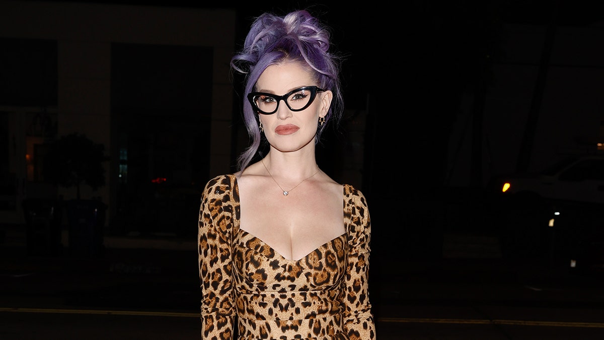 Kelly Osbourne wearing a leopard dress and cat-eye glasses
