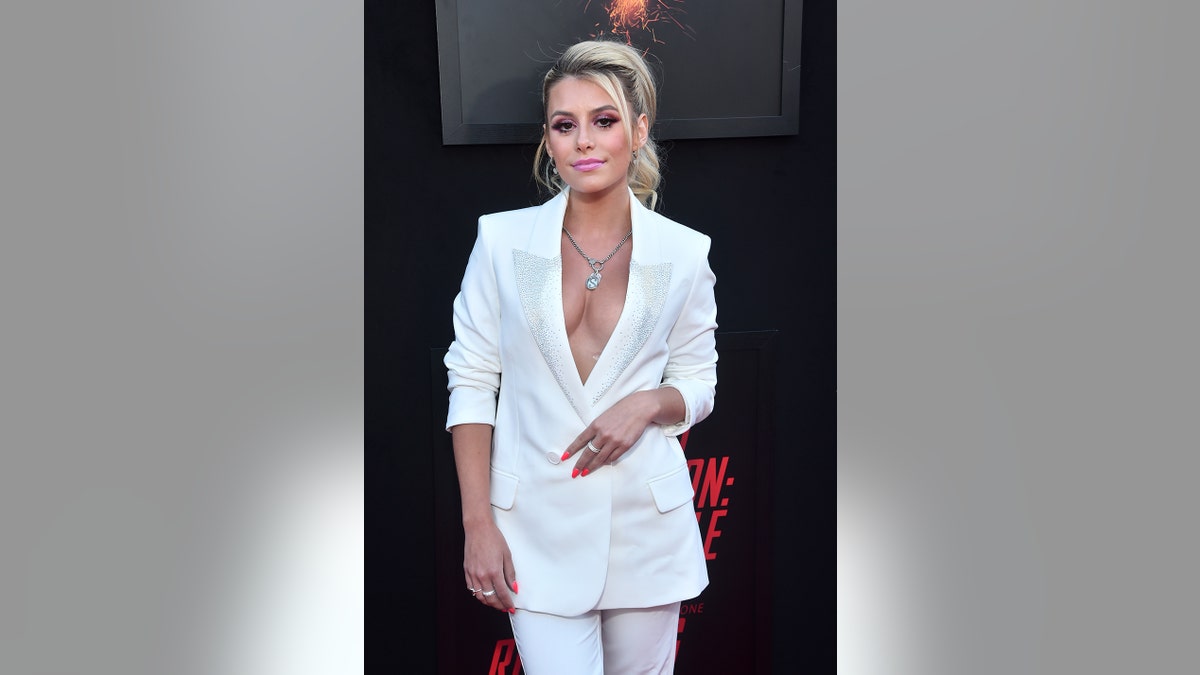 Madisyn Shipman wearing a white low cut suit