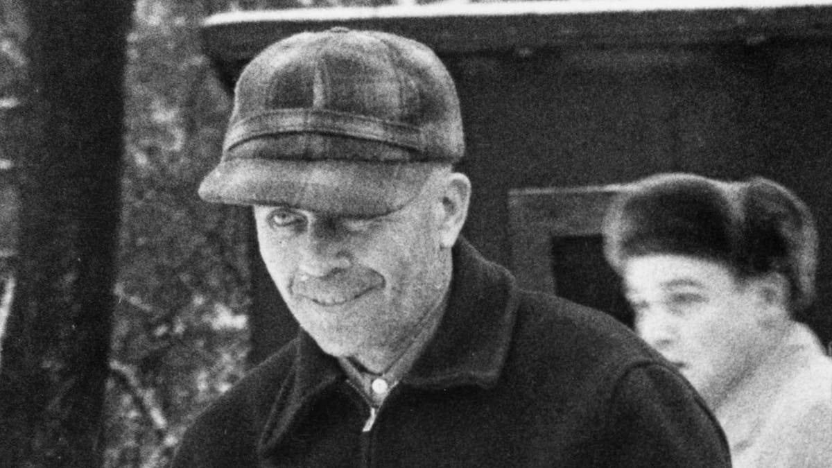 A close-up of Ed Gein with a sinister smile
