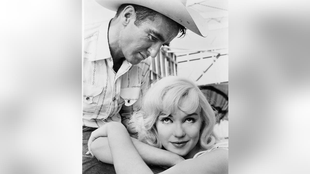 Montgomery Clift looking down at Marilyn Monroe