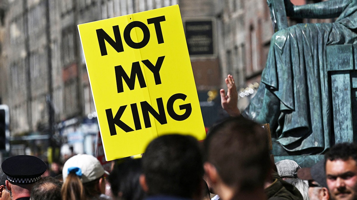 A close-up of a yellow sign that reads not my king