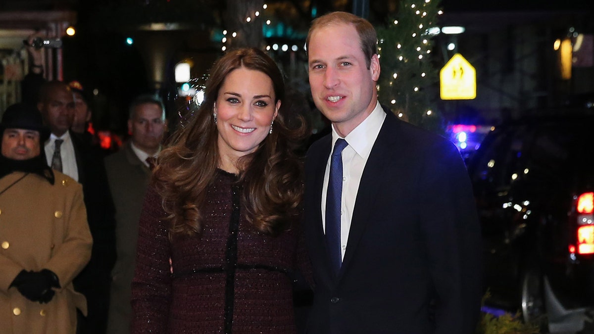 A close-up of Prince William and Kate Middleton smiling outdoors in New York City at night
