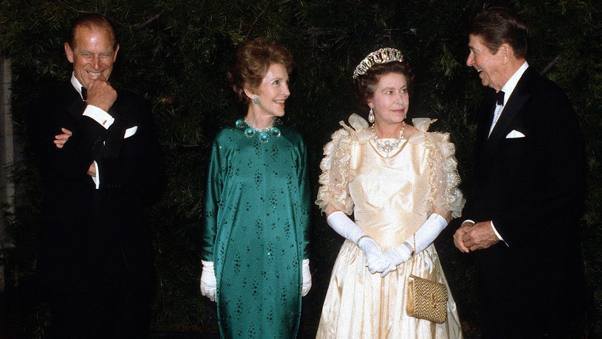 Prince Philip and Queen Elizabeth in formal wear as they are greeted by first lady Nancy Reagan and President Ronald Reagan
