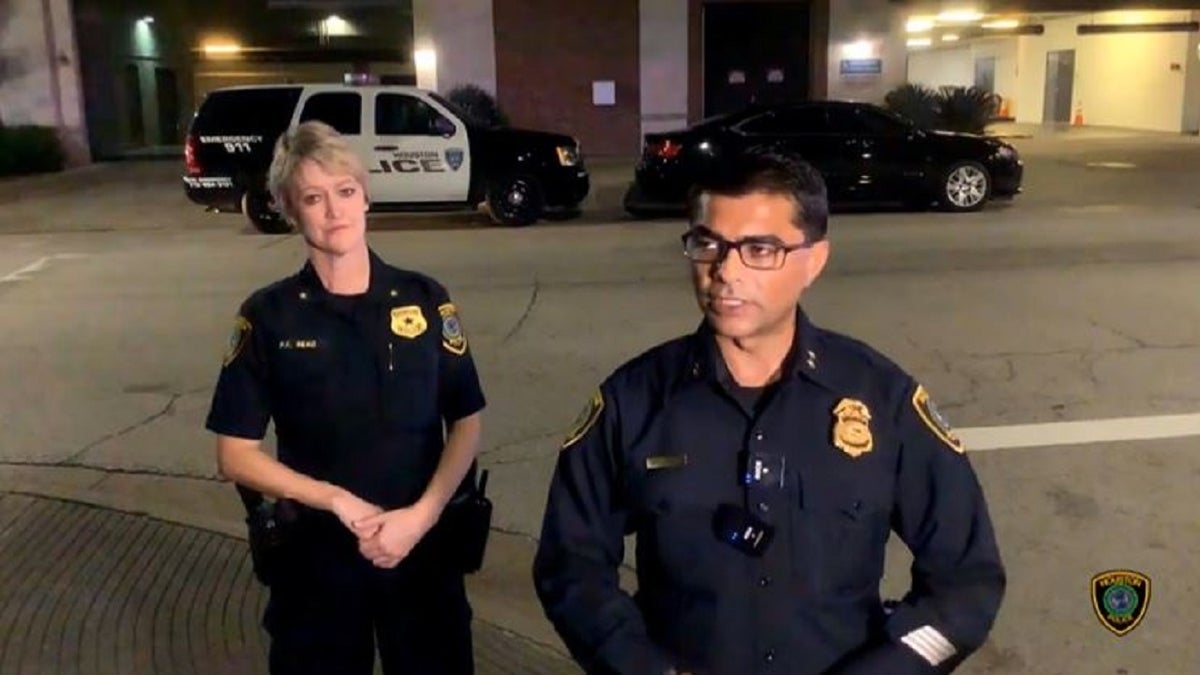 Houston Assistant Chief Yasar Bashir stands next to another officer in front of reporters outside a residential building where an off-duty Texas Department of Public Safety Trooper shot a man he believed was trying to break into his apartment unit. 