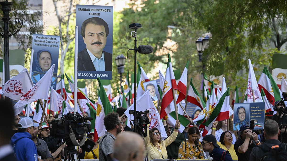 Protestors whole signs and the Iranian flag outside the United Nations Assembly