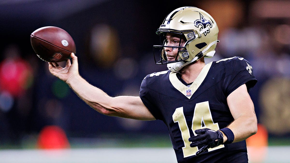 Jake Haener of the New Orleans Saints drops back to pass during