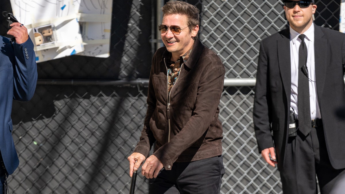Jeremy Renner walks with a cane