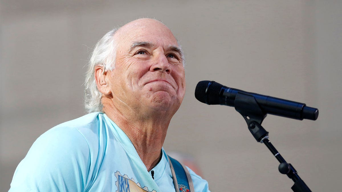 Jimmy Buffett sits at microphone