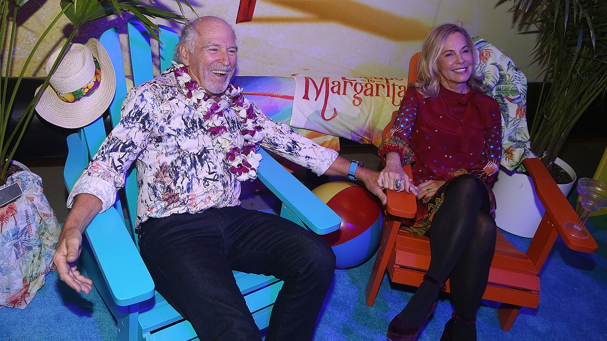 Jimmy Buffett and Jane Slagsvol sitting on chairs at Margaritaville