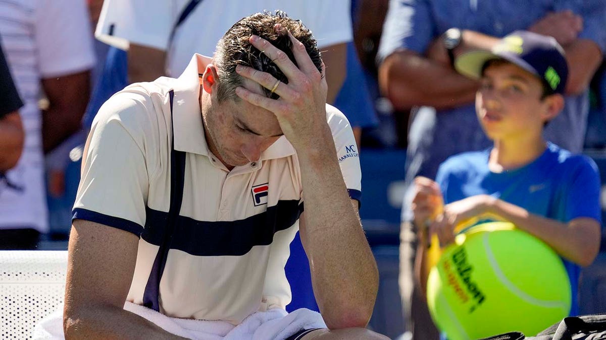 John Isner reacts after losing at U.S. Open