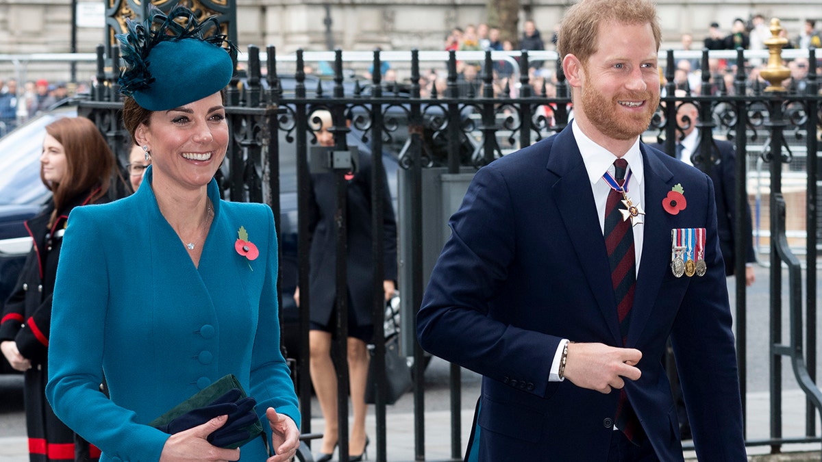 Kate Middleton and Prince Harry smiling and walking