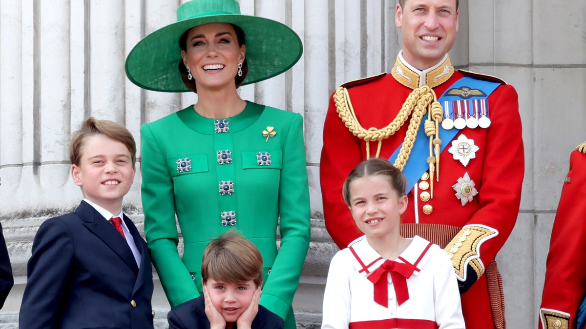 Kate Middleton, Prince William, Prince George, Princess Charlotte, and Prince Louis stand on the balcony at Buckingham Palace