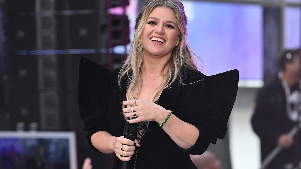 Kelly Clarkson smiling onstage