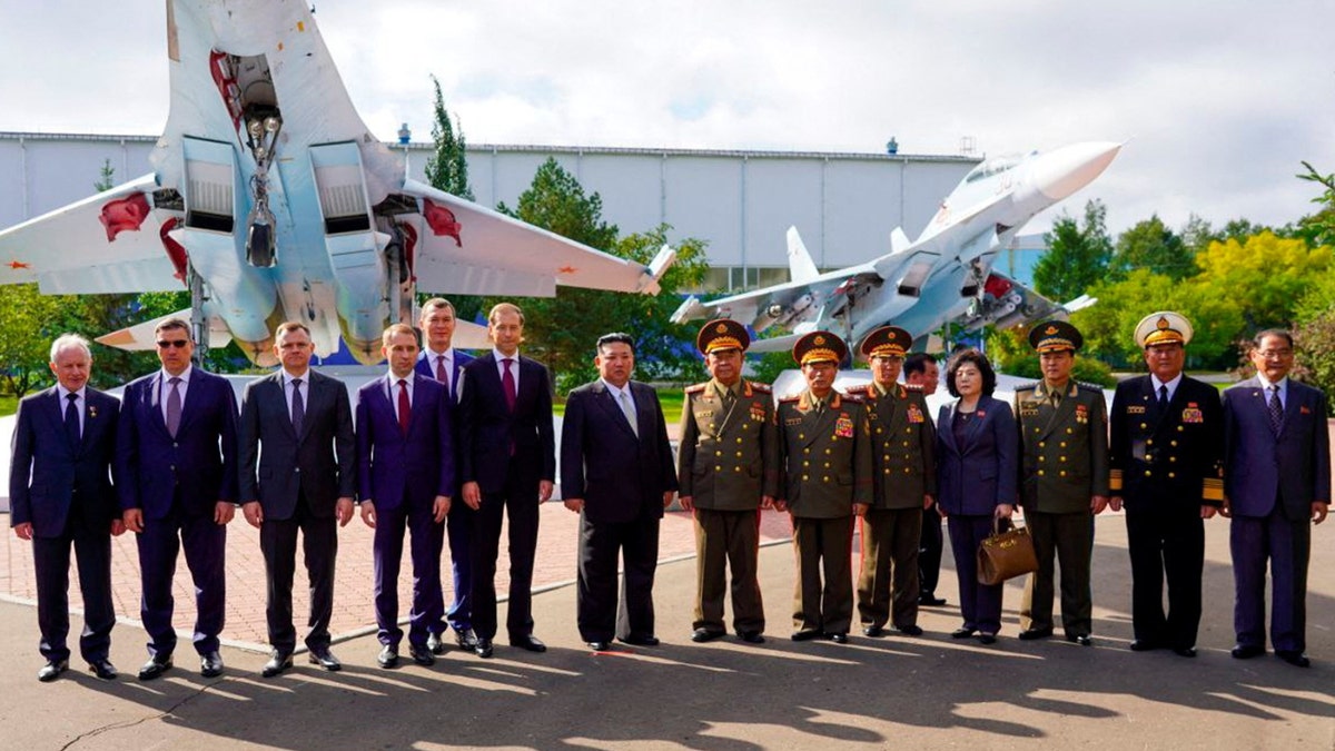 Kim Jong Un poses for photo at fighter jet factory in Russia