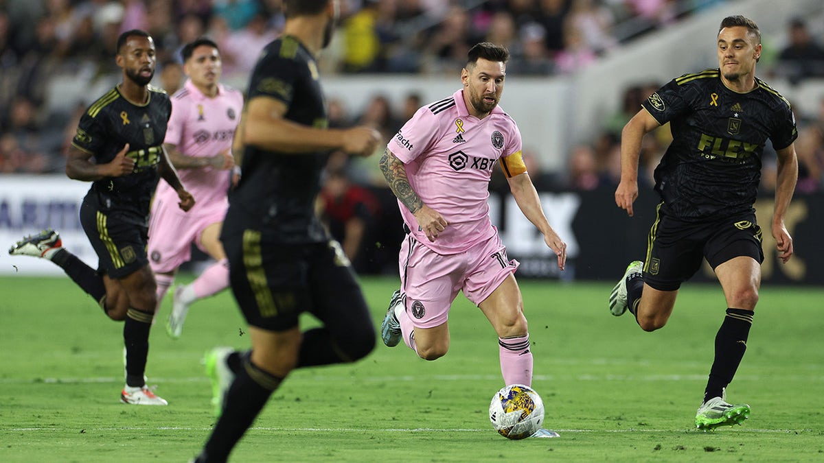 Lionel Messi runs on the soccer field