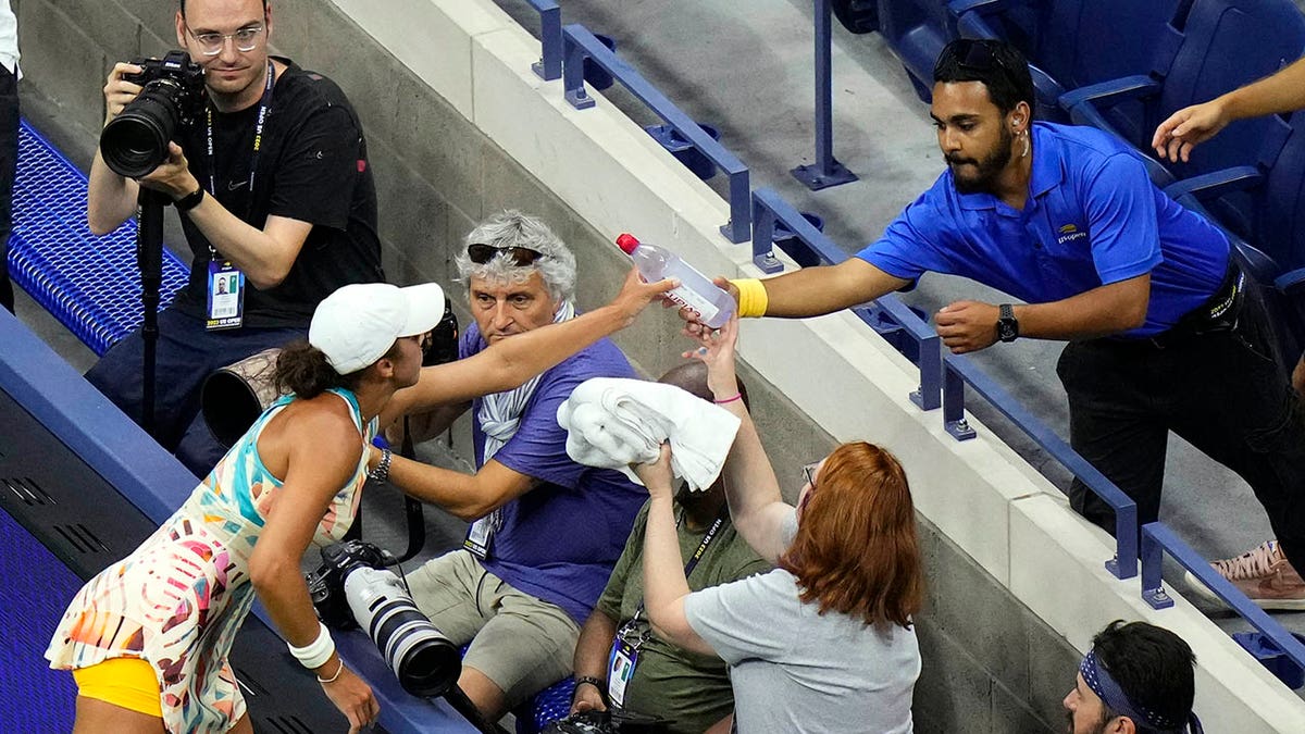 Madison Keys helps a patron