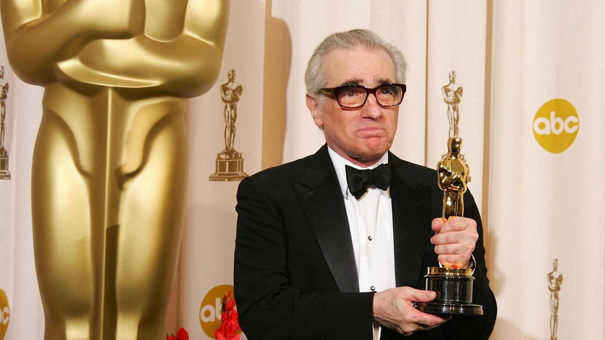 Martin Scorsese holding his Oscar