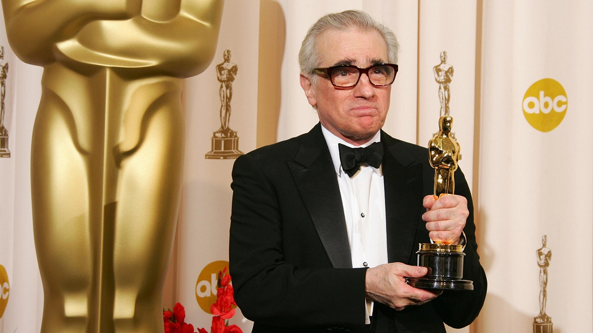 Martin Scorsese holding his Oscar