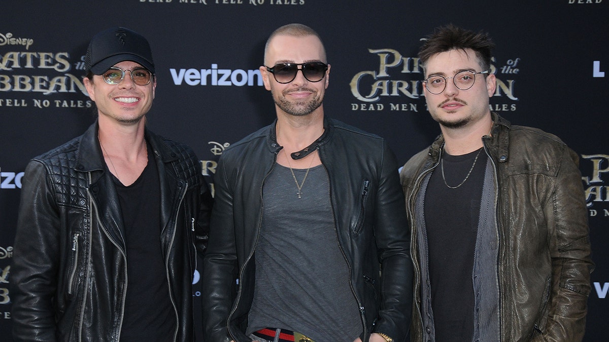 Matthew Lawrence, Joey Lawrence, and Andrew Lawrence posing together on the red carpet.