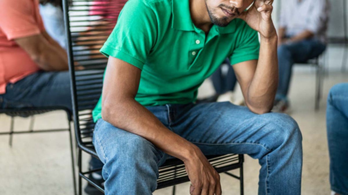 Hispanic man seated in chair stock image