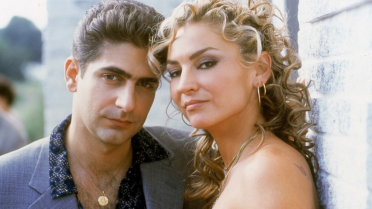 Michael Imperioli and Drea de Matteo posing for a promotional image of The Sopranos