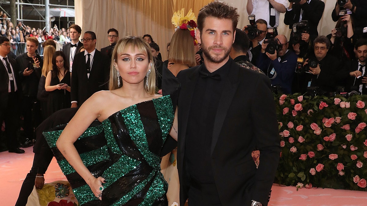 Miley Cyrus and Liam Hemsworth pose together
