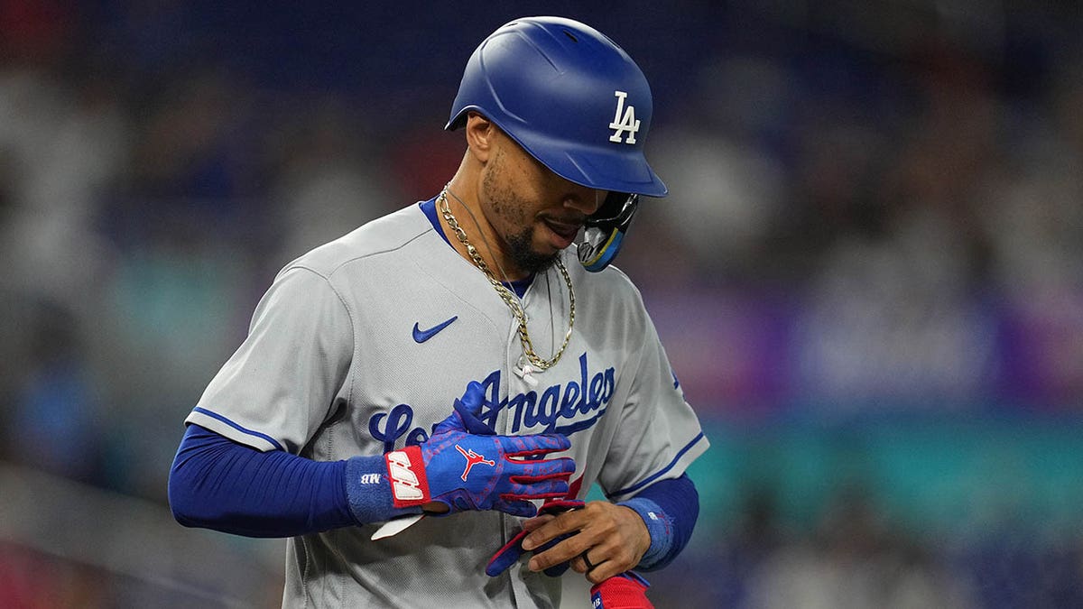 Mookie Betts removes his gloves