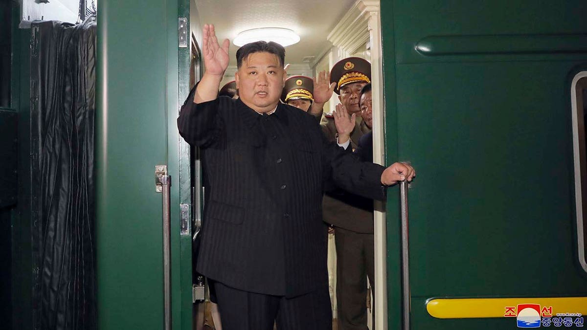  North Korea leader Kim Jong Un waves from a train