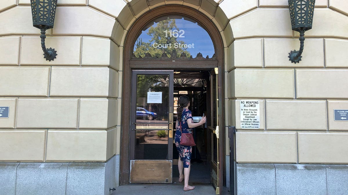 woman enters Oregon justice building