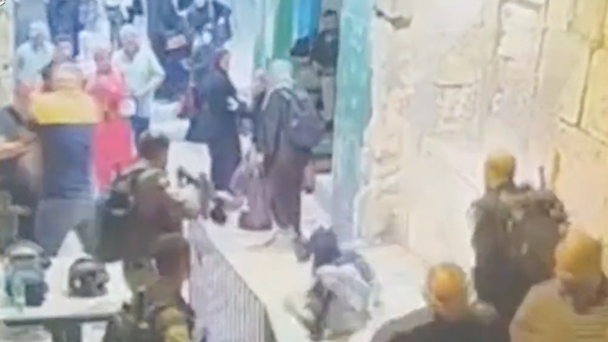 Palestinian woman kicked and pinned to the ground after attempting to stab Israeli policeman in Jerusalem