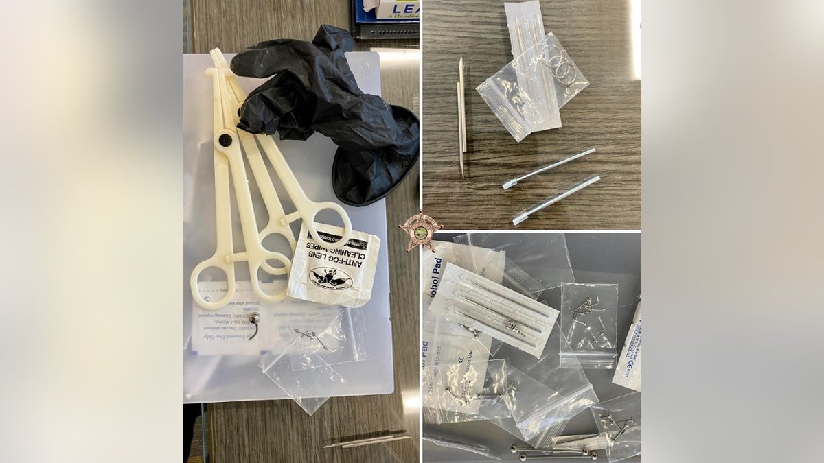 Piercing paraphernalia, including black gloves, scissors and piercings in multiple plastic bags