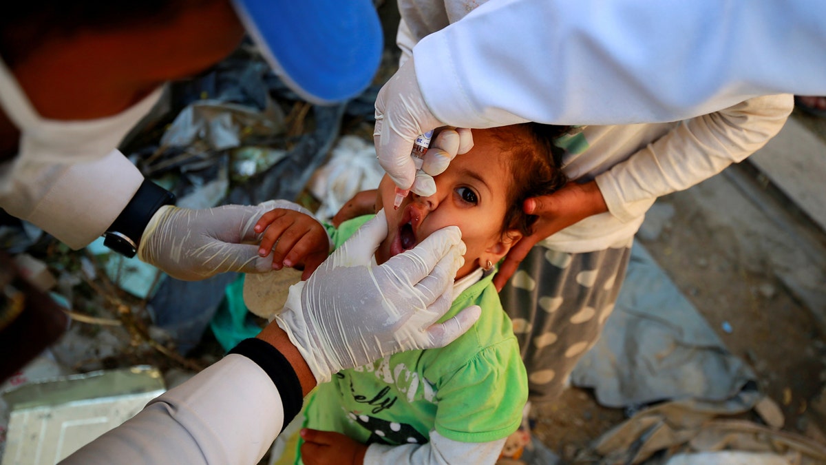 Girl receives a polio vaccine