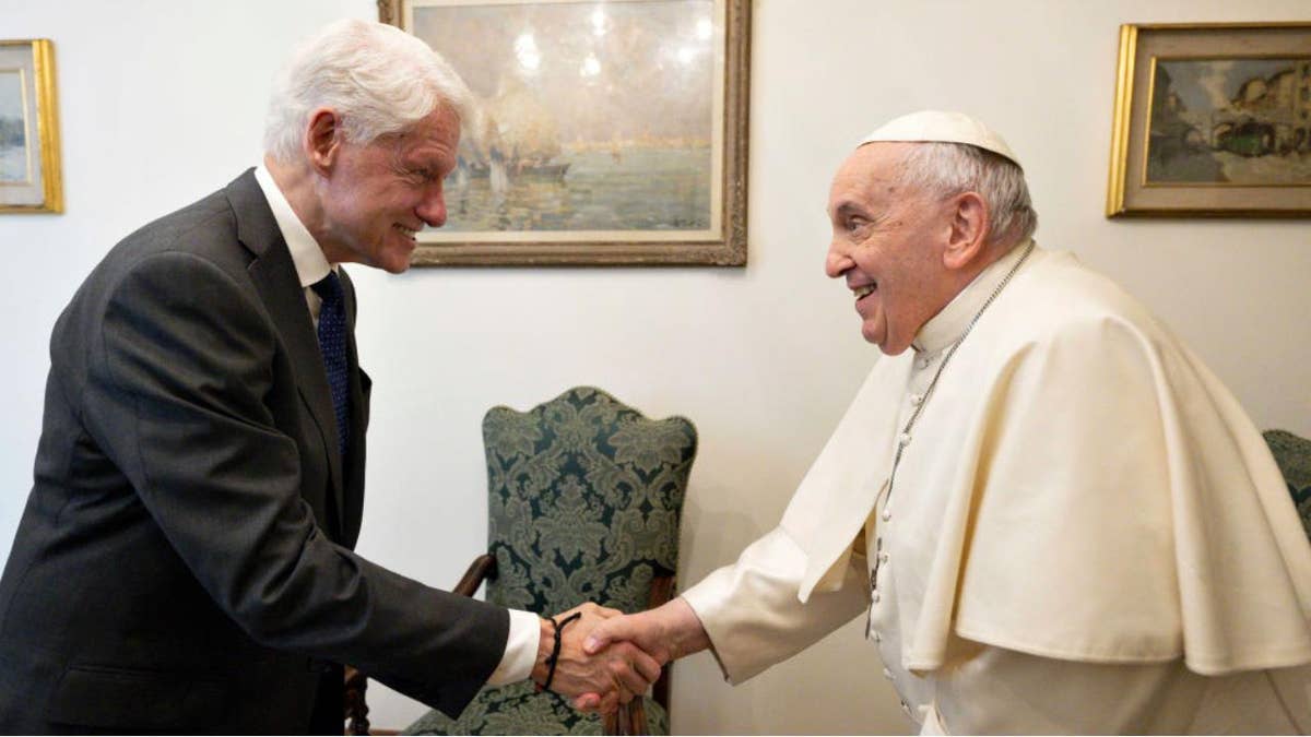 Bill Clinton shaking Pope Francis' hand at the Vatican