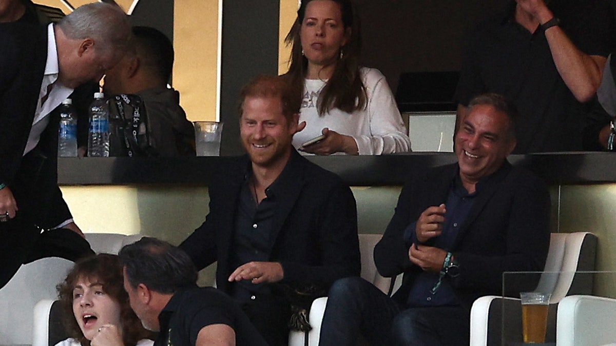 Prince Harry smiling at soccer game