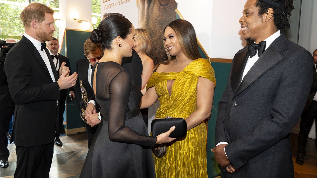 Prince Harry and Meghan Markle greeting Beyoncé and Jay-Z