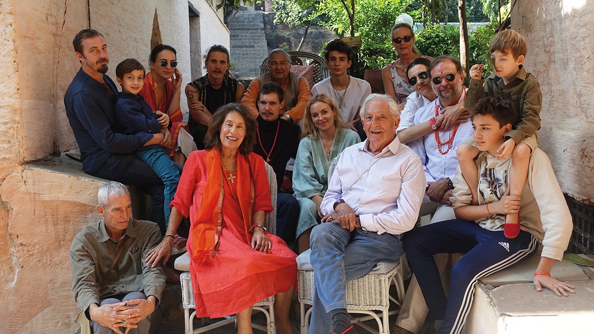 Prince Michael of Greece posing outdoors with his wife and their family